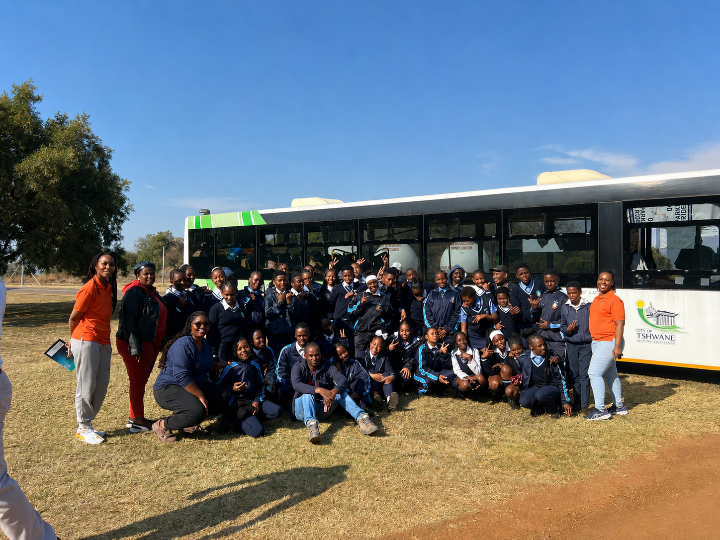STEM Ignited learners and programme team gathered beside a City of Tshwane bus during their SANSA Careers in Space visit.