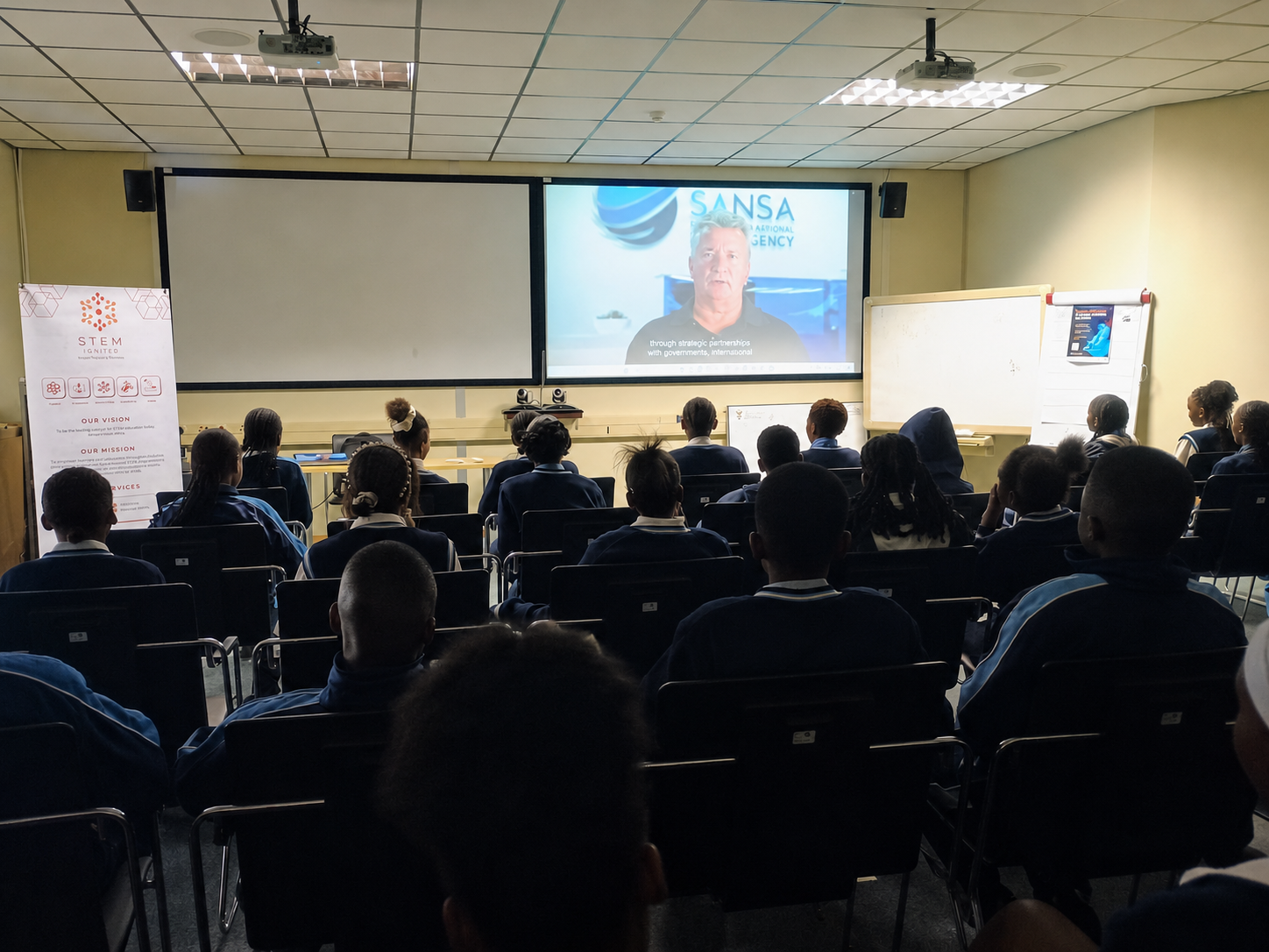 STEM Ignited learners seated in a presentation room watching a SANSA video during the 2026 Careers in Space programme.