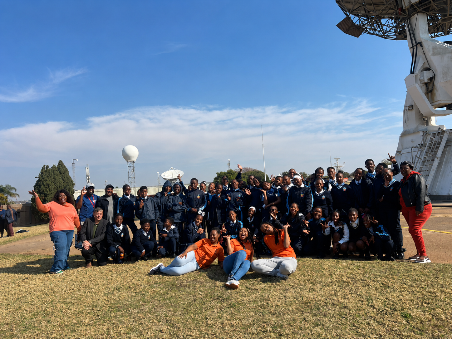 STEM Ignited learners and programme team posing near satellite and space science infrastructure during a SANSA career exposure visit.